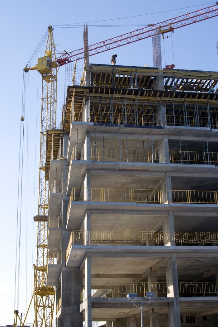 Services High-rise building under construction with a tower crane. Captures the modern construction process.