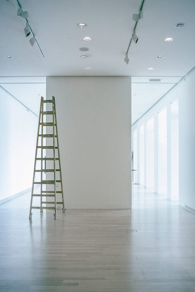 pexels photo 4947007 Wide indoor space with a ladder, showcasing LED lighting and modern minimalism.
